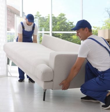 Two-Male-Movers-Moving-A-Furniture